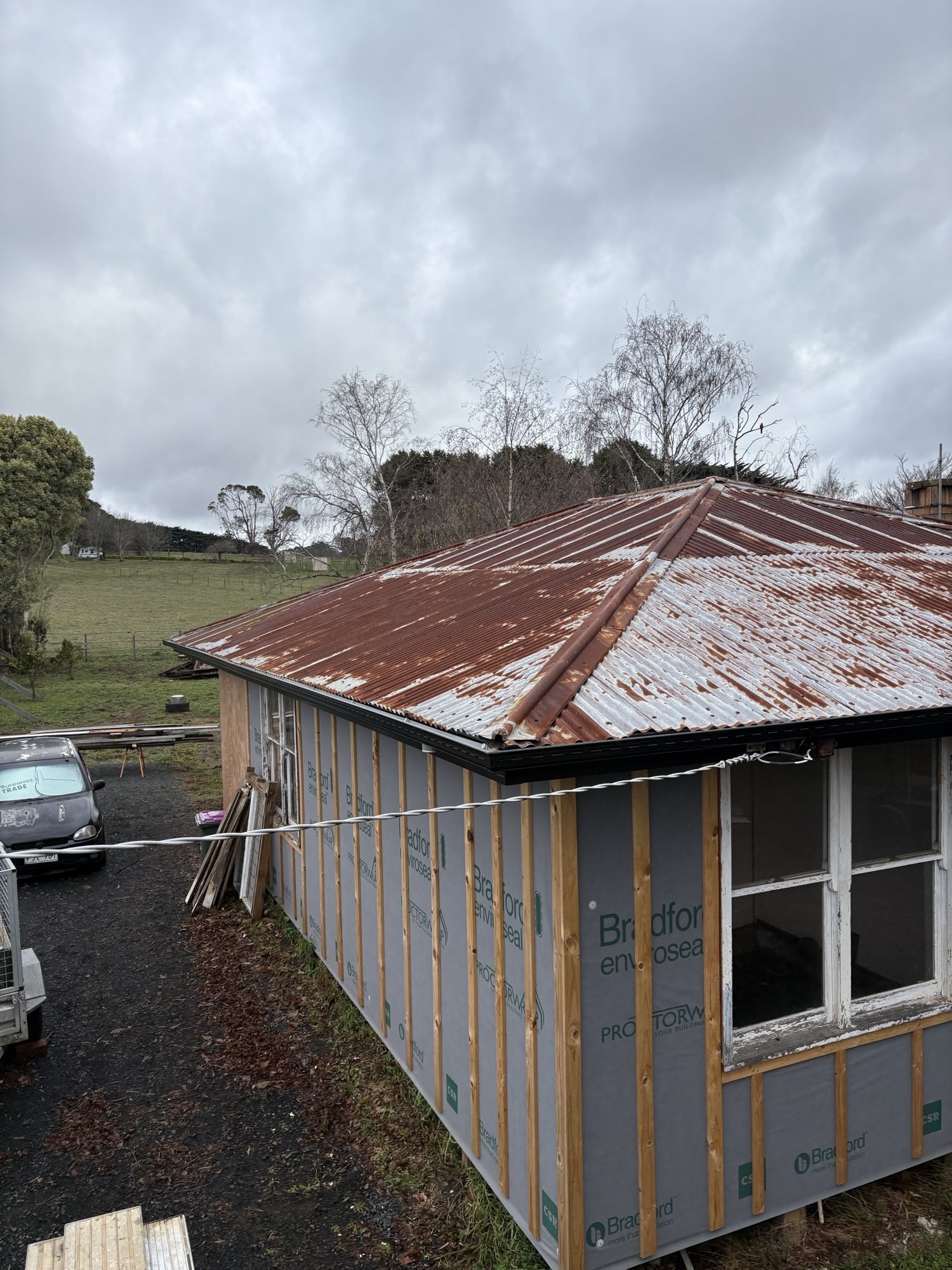 Before — rusted corrugated roof